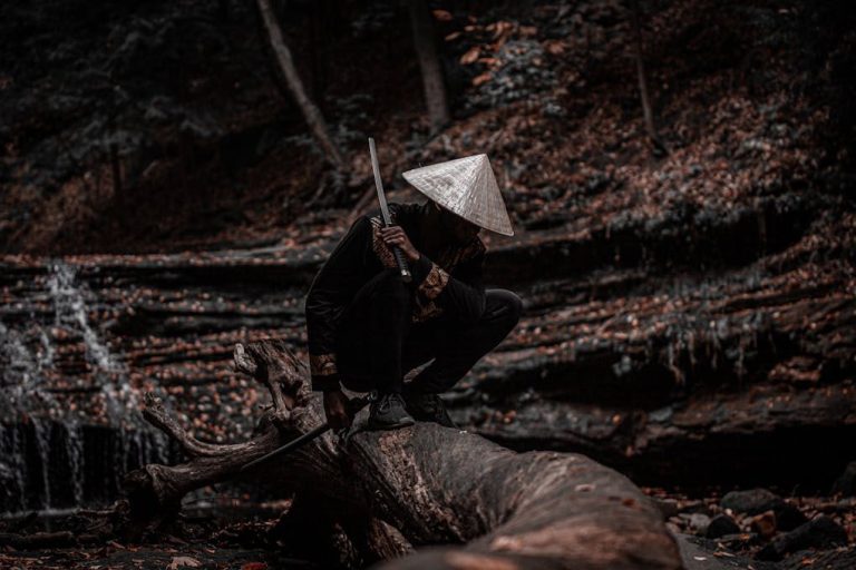 A dramatic scene of a samurai crouching on a tree trunk in a forest, wielding a sword.